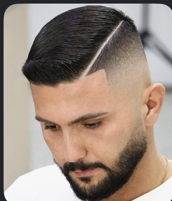 Hard part comb-over with a sharp skin fade by Tony Cutz