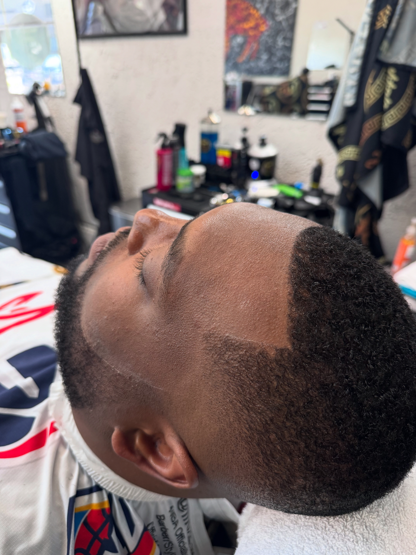 Crisp razor line-up and taper on natural hair by Tony's Beard ℰ Cuts