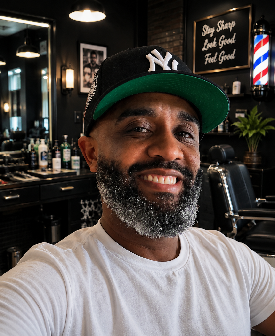 Tony, master barber at Tony Cutz, smiling in his barbershop