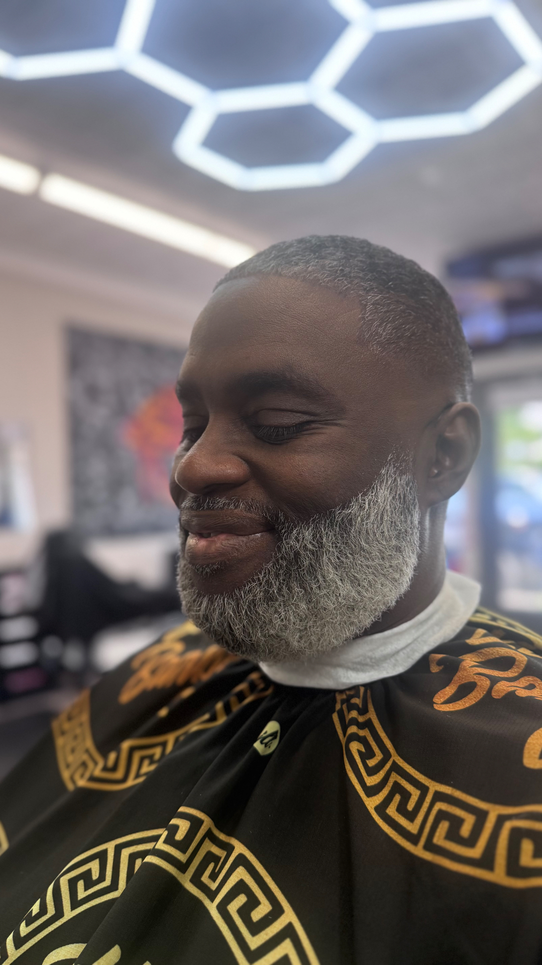 Silver low fade with a full shaped beard by Tony's Beard ℰ Cuts