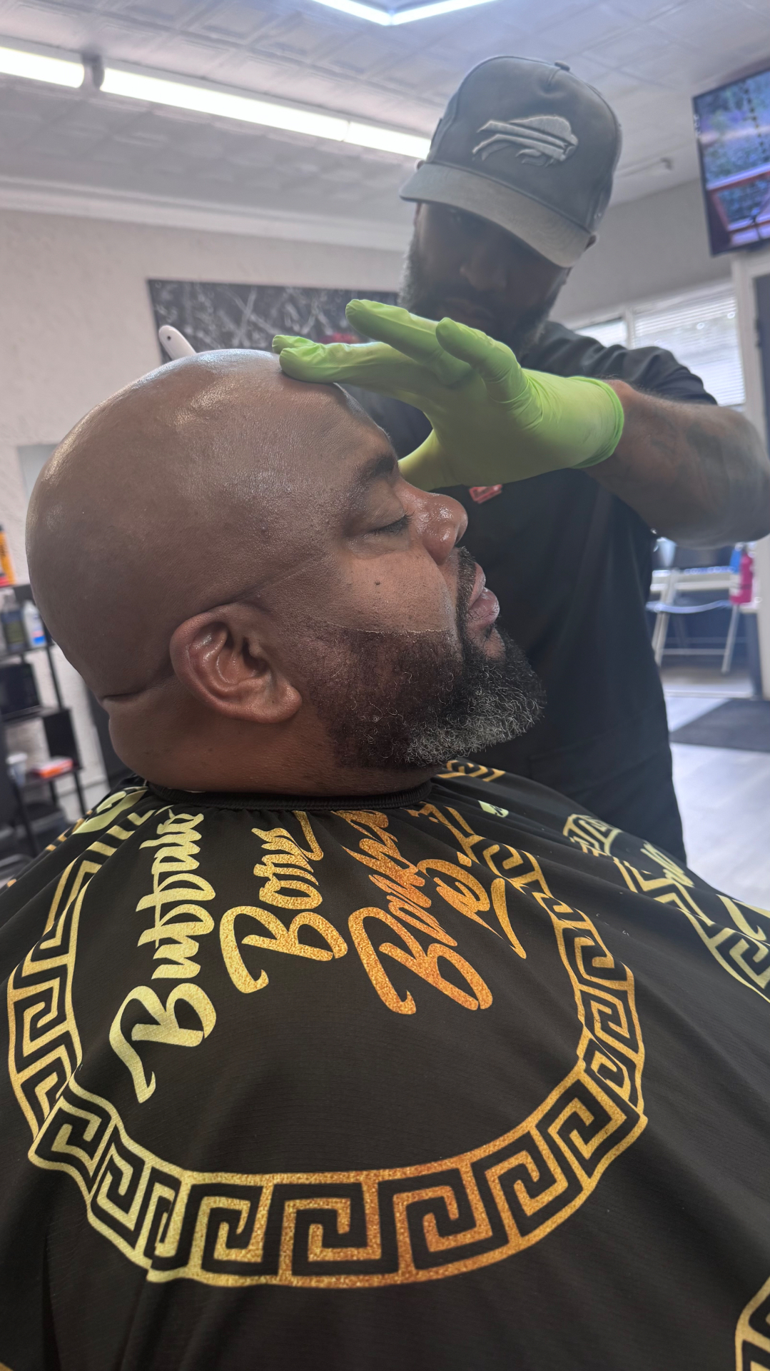 Bald head shave with sculpted salt-and-pepper beard by Tony's Beard ℰ Cuts
