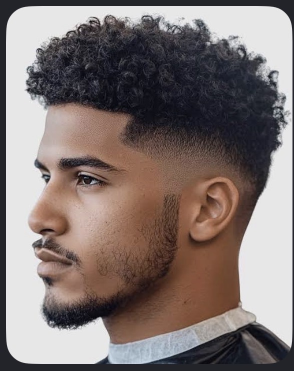 Curly top with a mid skin fade by Tony Cutz